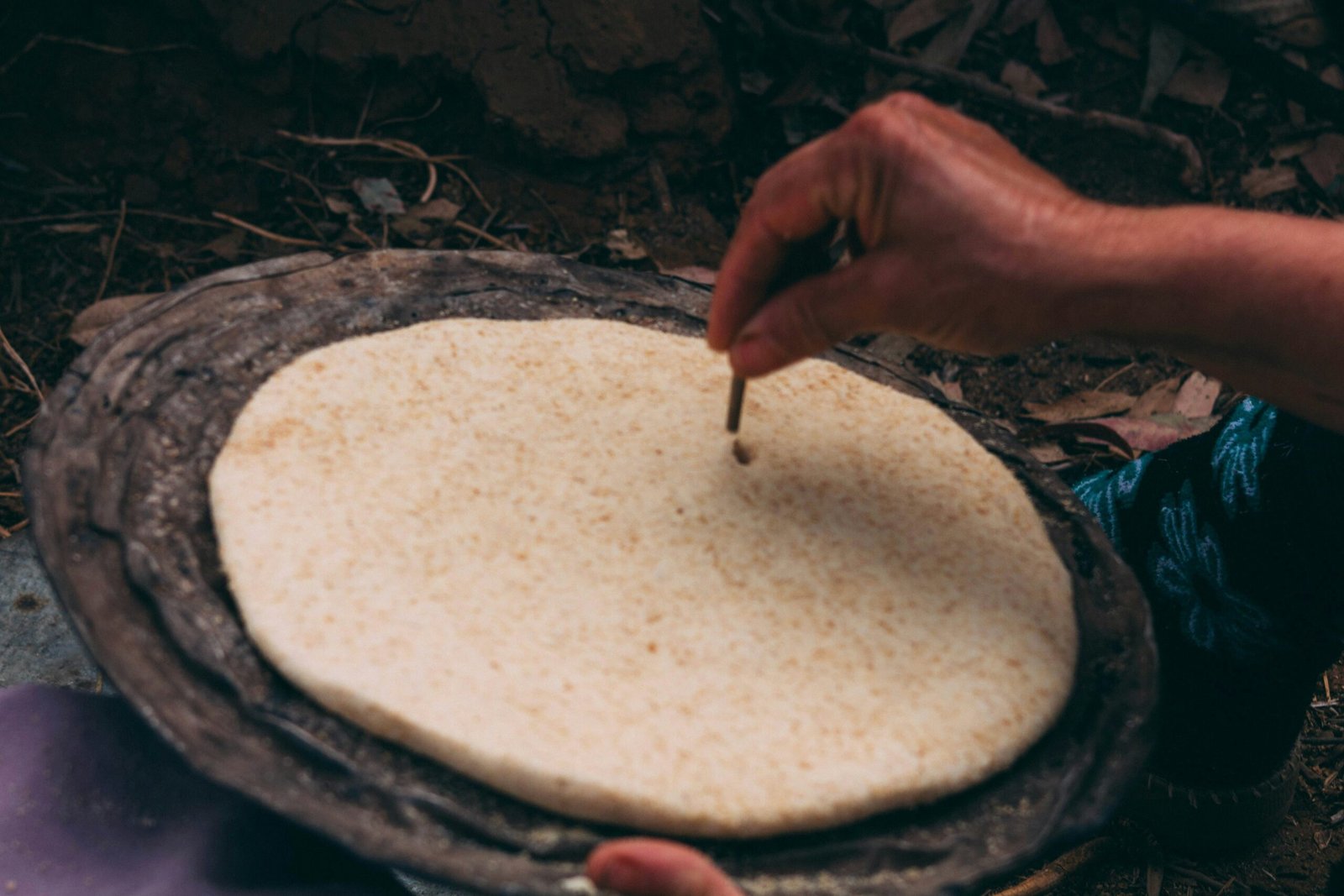 A person is putting something in a bowl